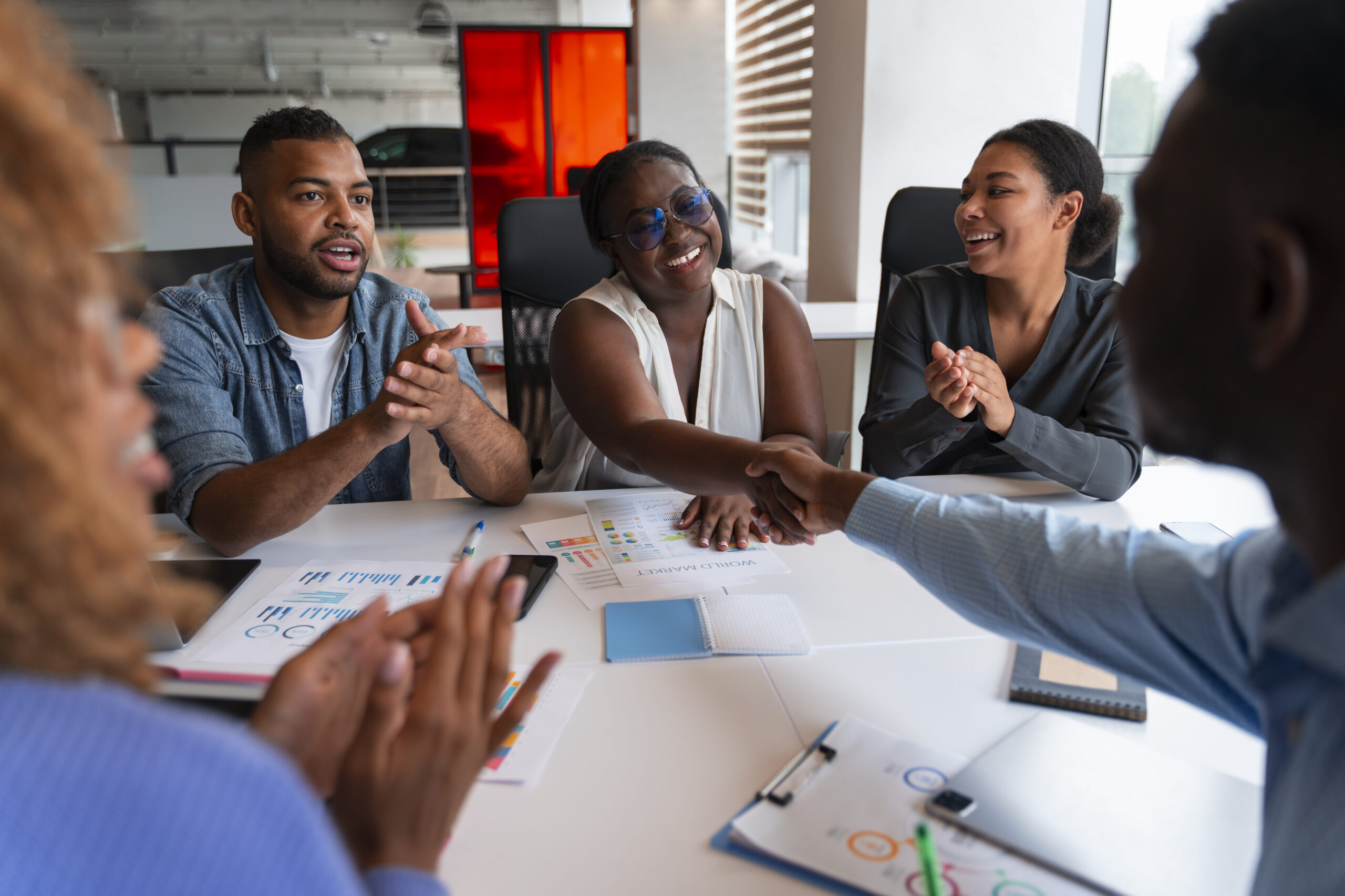 Onaba Group Consulting consultants and a client team shaking hands over a strategy session