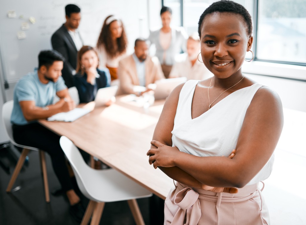 A consultant standing in front of a team meeting in a boardroom